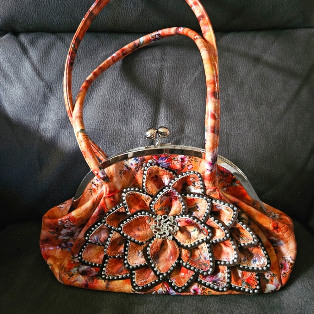 Purse-shiny orange with flowers and bling. Only used a couple times. 14" x 9"